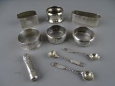 SIX VARIOUS SILVER NAPKIN RINGS, an amber type cheroot holder in silver container and three