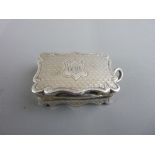 AN OBLONG SILVER VINAIGRETTE with bright cut shaped rim, initials to the lid, grill intact, 18 grms,