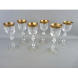 A SET OF SIX BOHEMIAN TWENTY TWO CARAT GOLD RIMMED DRINKING GLASSES, 19 cms high