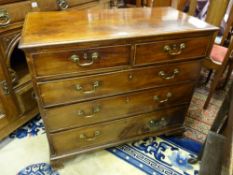 AN EARLY 19th CENTURY MAHOGANY CHEST of two short over three long drawers having pommel plates and