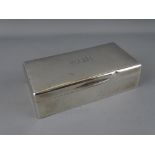 A RECTANGULAR SILVER CIGARETTE BOX with cedar wood lining, London 1922, 17.5 cms long