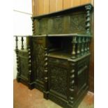 A CARVED OAK INVERTED BREAKFRONT SIDEBOARD with upper panelled back, 137 cms high, 129 cms wide,