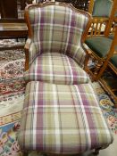 A MODERN FRENCH STYLE ARMCHAIR & FOOTSTOOL in broad check upholstery, 88 cms high, 65 cms wide, 65