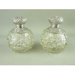 A PAIR OF GLOBULAR HOBNAIL CUT SCENT BOTTLES with embossed silver tops and collars, Birmingham 1899,