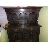 A 19th CENTURY CARVED OAK SMALL HOODED HIGH DRESSER, the upper section having three pillared