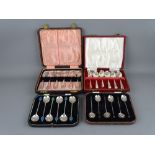 TWO SETS OF SIX SILVER TEASPOONS and two sets of silver cocoa bean spoons, all cased, all