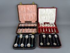 TWO SETS OF SIX SILVER TEASPOONS and two sets of silver cocoa bean spoons, all cased, all