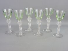 A SET OF SIX ART DECO DRINKING GLASSES with uranium bowls and frosted nude figurine stems, 16 cms