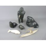 A COLLECTION OF INUIT CARVED ORNAMENTS to include a standing Eskimo figurine holding a knife, a