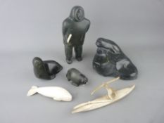 A COLLECTION OF INUIT CARVED ORNAMENTS to include a standing Eskimo figurine holding a knife, a