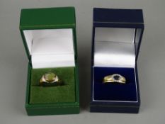 TWO NINE CARAT GOLD DRESS RINGS including an oval cabochon set example with diamond chips to