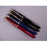 Four Vintage Parker Slimfold fountain pens (two black, one blue, one red), all with 14k nibs