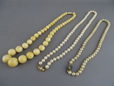 AN IVORY GRADUATED BEAD NECKLACE, a freshwater pearl necklace with oval nine carat gold clasp having