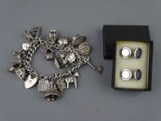 A SILVER CHARM BRACELET with twenty one charms, 2.8 troy ozs and a pair of Tiffany sterling silver