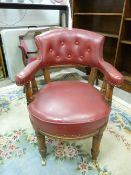 A VINTAGE OAK OFFICE ARMCHAIR with button back upholstery, 84 cms high, 63.5 cms wide, 70 cms deep