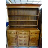 AN ANGLESEY OAK & MAHOGANY BREAKFRONT DRESSER, fully opening drawers with diamond escutcheons and