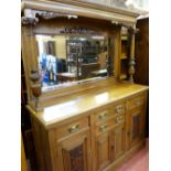 A GOOD HONEY OAK LATE VICTORIAN MIRRORBACK SIDEBOARD with good carved detail and chamfered panel