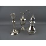 A SILVER SUGAR SIFTER, a single candlestick and a small ewer type jug both having loaded bases,
