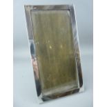 A PLAIN SILVER EASEL PICTURE FRAME to take a picture 22 x 10.5 cms, Birmingham 1923