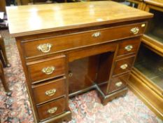A NEAT MAHOGANY PEDESTAL DESK with kneehole cupboard centre and oak lined drawers, 77.5 cms high,
