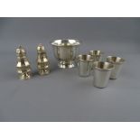 A STERLING SILVER BOWL, four small beakers and a pair of Chester 1906 pepper pots, 5.3 troy ozs