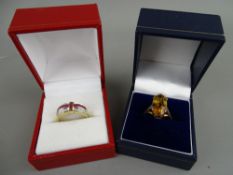 TWO NINE CARAT GOLD DRESS RINGS including an Art Deco style cross, set rubies with diamonds example,
