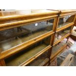 A PAIR OF GLOBE WERNICKE THREE SECTION LIGHT OAK STACKING BOOKCASES with labels, 115.5 cms high,