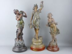 THREE PAINTED SPELTER FIGURINES OF YOUNG MAIDENS in various poses, 53 cms high the tallest, all