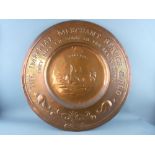 A RARE NEWLYN COPPER WALL CHARGER for the Imperial Merchant Service Guild, 59.5 cms diameter,