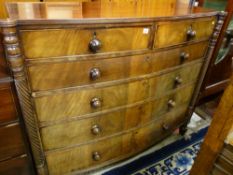 A REGENCY MAHOGANY BOW FRONT CHEST of two short over four long drawers with twist carved column