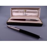 Vintage black Parker 25 fountain pen with 14k nib and a Vintage red Parker 51 fountain pen (with