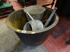 Cast iron foundry boiler and an old galvanized bucket and watering can
