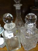 Three glass decanters with stoppers