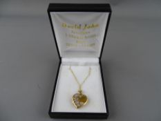 Nine carat gold heart shaped locket and chain, 3 grms