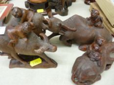 Four carved bisons with mounted figures