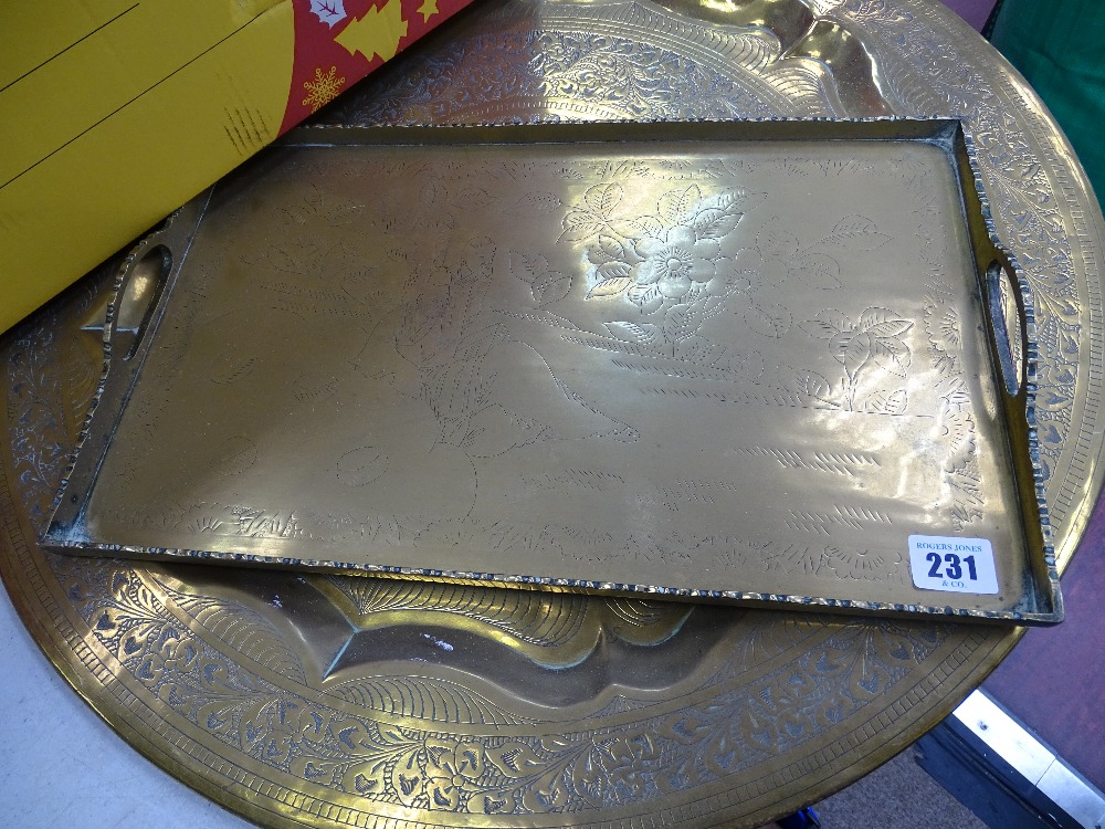 Oblong galleried twin handled brass tray and a circular charger