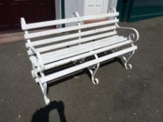 White painted wooden slatted scrolled metal garden bench