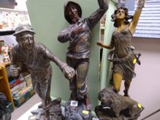 Three spelter figurines of a fisherman, classical figure with plaque 'Le Pouvoir' etc