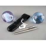 Parker stainless steel ballpoint pen and pencil set in case and two Caithness glass paperweights