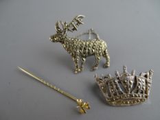 Marcasite stag brooch marked 'Sil', a marcasite crown brooch and a nine carat gold clover leaf