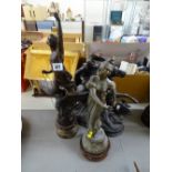 Spelter horse and rider and two standing figurines on circular bases