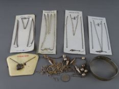 Silver bangle, locket on chain and four sterling silver necklaces in original packaging, a vintage