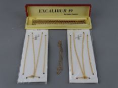 Three nine carat gold necklaces, two in original packaging, approximately 3 grms gross and a boxed