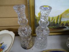 Two cut glass thistle shaped decanters with stoppers