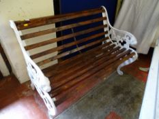 Dark stained wooden slatted bench with ornate metal ends