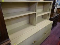 Modern light wood bookshelf with three base cupboards