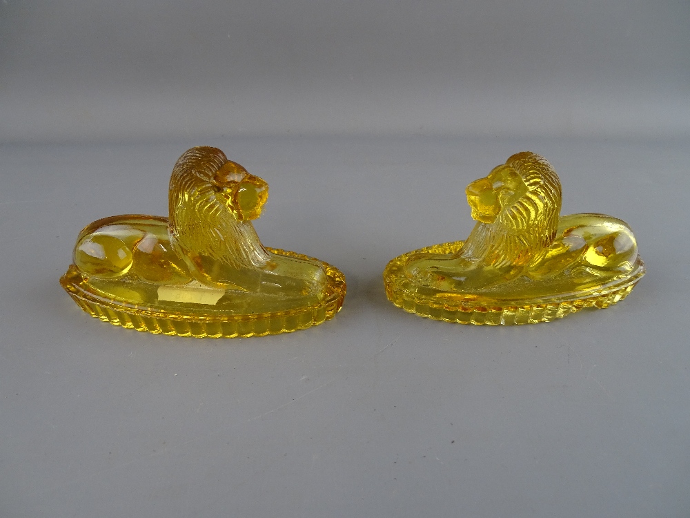 Pair of amber glass recumbent lions