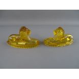 Pair of amber glass recumbent lions