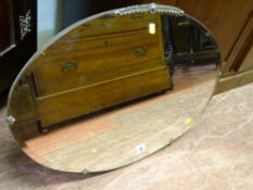 Oval bevelled edge mirror with metal embellishments