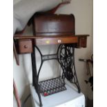 A vintage treadle Singer sewing machine on cast metal stand